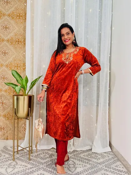 This rust-orange velvet kurta is a unique and warm color for winter. The delicate embroidery adds a touch of festive charm.
