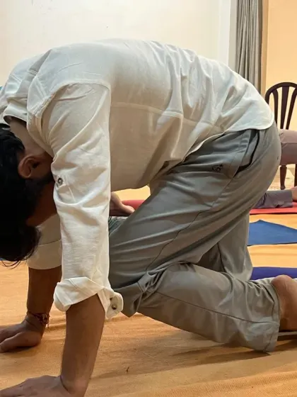 A participant deeply involved in a posture during a Surya Kriya class. The practice demands a certain level of involvement to reap its full benefits.