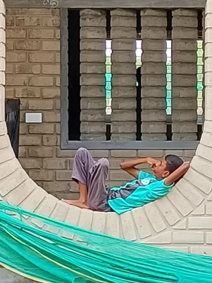 We believe architecture should be playful and invite interaction. At the Sai Kirupa Special School in Tiruppur, a student finds a moment of rest in an inverted arch, a feature that has become one of the most loved elements of the campus, showing how design can create moments of joy and belonging.