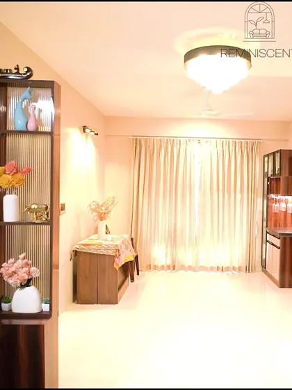 A bright and airy living room with light wood and glass display units, creating a sense of openness and elegance.