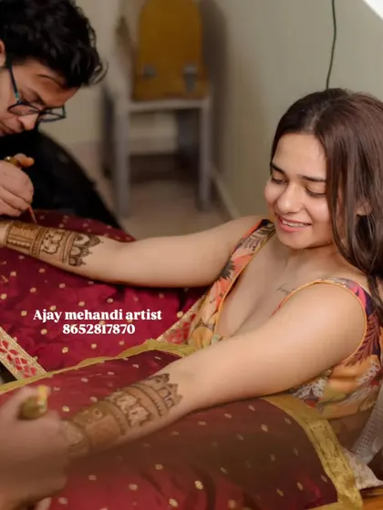 A candid shot of one of our artists applying mehndi to a smiling guest. We pride ourselves on being friendly and professional, making the experience enjoyable for everyone.