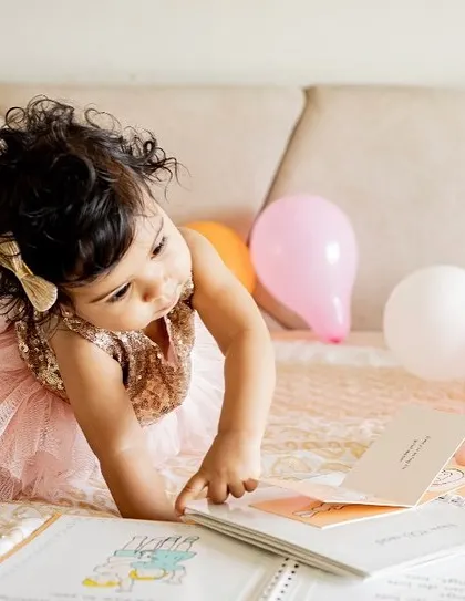 I love capturing toddlers engrossed in their favorite books. It's a sweet, quiet moment that makes for a cherished memory of their early interests.