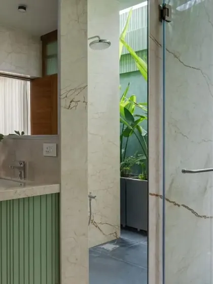 The master bathroom in the Earthen Anthem penthouse features a skylit shower that opens to a private green space, bringing the outdoors in.