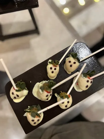 White chocolate-dipped strawberries decorated to look like little ghosts. These were a fun and spooky treat for a Halloween party.