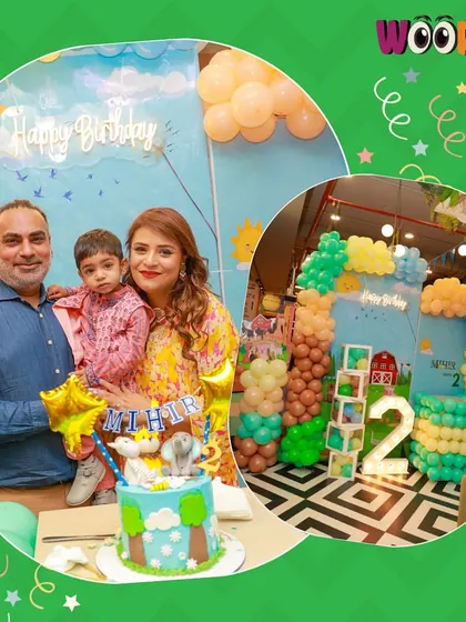 A family poses with their son and his farm animal-themed cake at his 2nd birthday party.