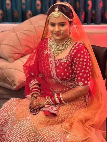 Another angle of this lovely bride, showcasing the traditional matha patti and nath. Her look is a testament to timeless bridal beauty.
