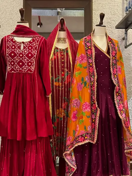 A collection of rich red and maroon velvet outfits. Velvet is a luxurious choice for winter weddings, and these pieces with their intricate embroidery and floral dupattas are perfect for the occasion.