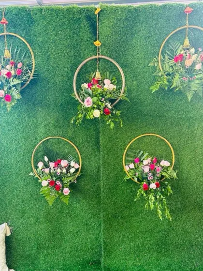 A close-up of the handcrafted floral hoops, made with roses, carnations, and ferns, used for the Mehendi backdrop.