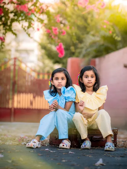 We loved this outdoor session with twin sisters. Their matching outfits and serious expressions, combined with the beautiful backlighting and natural setting, created a truly striking and memorable portrait.