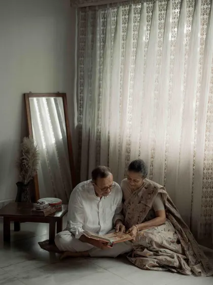 A wider view of their quiet afternoon, reminiscing together. The entire scene, with the soft curtains and warm light, felt like a painting of domestic bliss and enduring love.