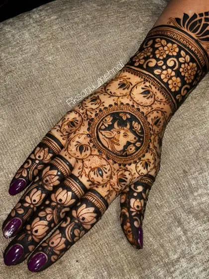 This design features a central portrait of a cow, a sacred animal, surrounded by a field of lotus flowers. It's a wonderful example of how we can incorporate unique and symbolic figures into your mehndi.