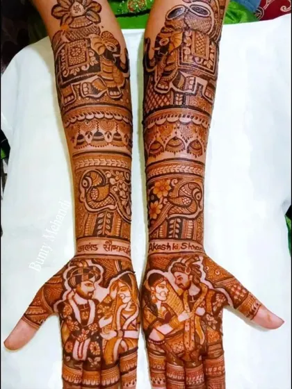 A beautiful example of incorporating the couple's names, 'Akash' and 'Sheena', directly into the intricate design on the forearms.