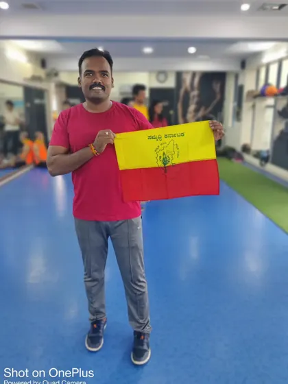 A member proudly holding the Kannada flag during our Rajyotsava celebration. We are proud to be a part of the vibrant culture of Karnataka.