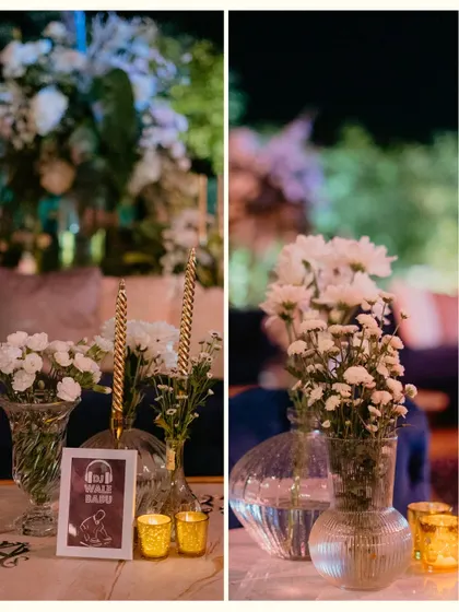 A collage of table details from a Sangeet, featuring quirky framed signs, simple floral arrangements in glass vases, and the warm glow of golden votives.