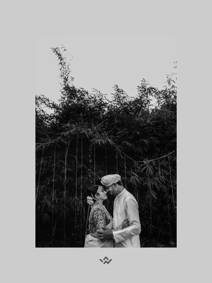A timeless black and white portrait of the couple sharing an intimate moment against a backdrop of bamboo trees.