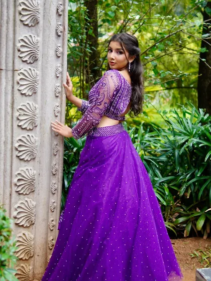 Another angle of the purple beaded lehenga, showing the stunning back detail of the blouse.