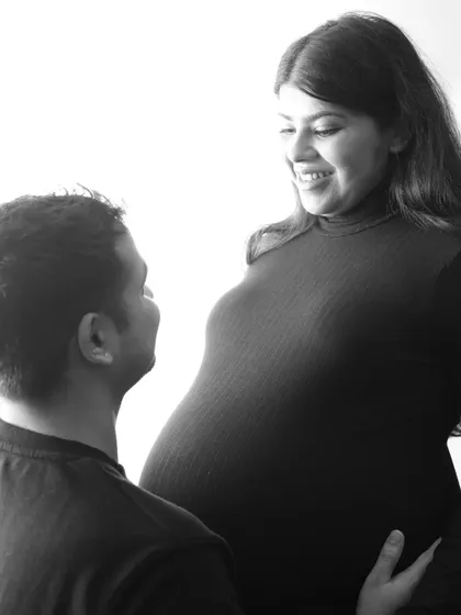A sweet and intimate black and white close-up. The couple shares a look of love and happiness, a simple moment that says everything about their connection.