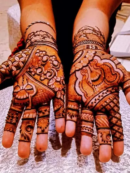 A beautiful and full design for the palms, combining floral, peacock, and geometric elements.