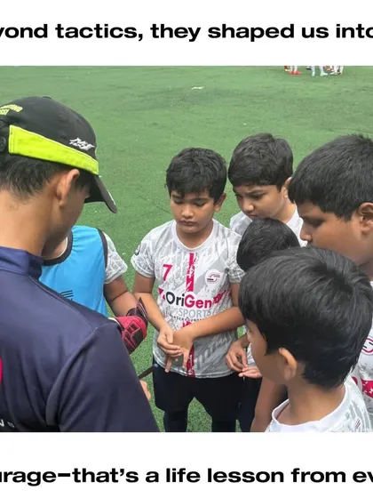 A coach giving tactical instructions to our young players. This image captures the essence of mentorship: guiding the next generation with focus and encouragement.