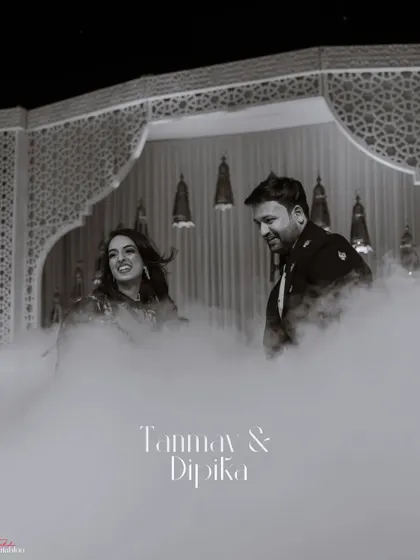 A dreamy, black and white portrait of Tanmay and Dipika making their entrance through a cloud of smoke. This artistic shot adds a touch of mystery and romance to their Sangeet night.
