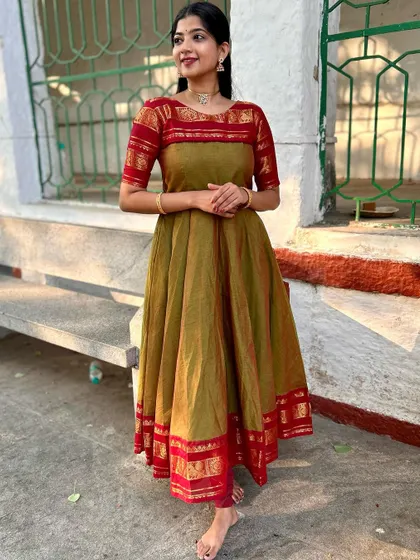 Celebrating Ugadi in a beautiful olive green and red Anarkali. The dress is made from cotton with a traditional temple border, blending comfort with festive style.