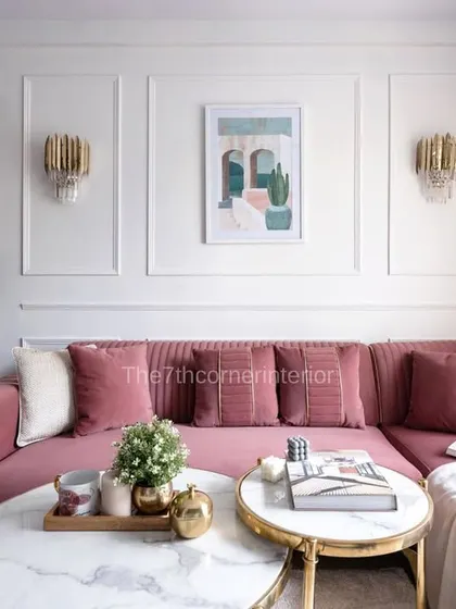 A side-by-side comparison of the 3D design and the actual living room, showing the faithful execution of the wall paneling, pink sofa, and modern art.