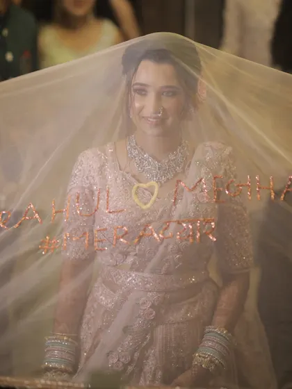 A creative entry with a custom veil. The bride looks magical behind the sheer fabric.