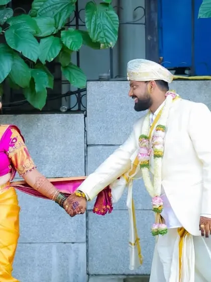 The newlyweds take their first steps together. This candid shot captures the beginning of their journey, framed by their traditional attire and the joy of the moment.