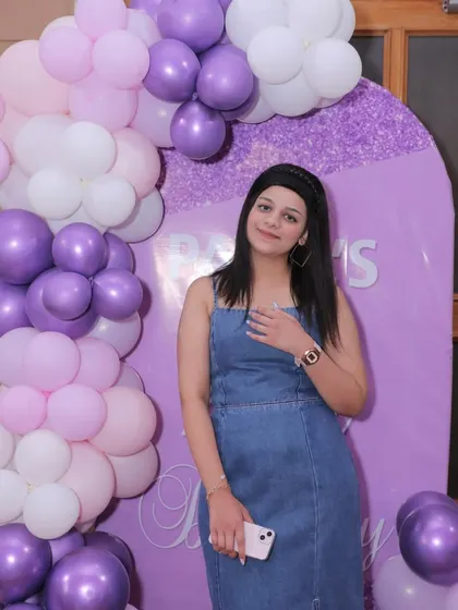 A beautiful portrait of the birthday girl enjoying her custom-decorated party space.