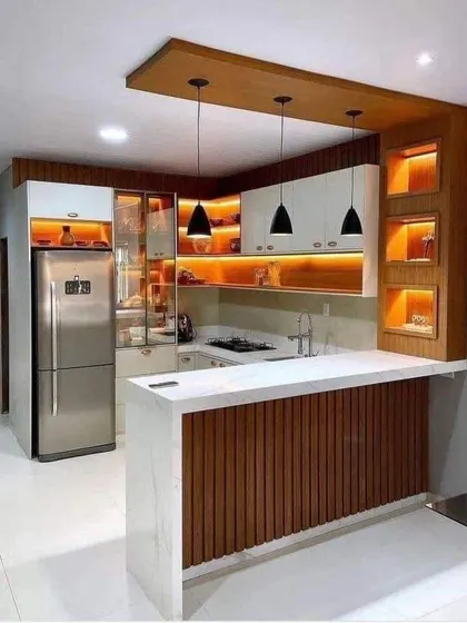 This design shows how lighting can transform a kitchen. The backlit open shelves and under-cabinet lights create a beautiful, layered glow that makes the whole space feel warm and luxurious.