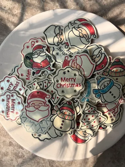 My Christmas charms catching the morning light. Each one is hand-cut and painted, making them tiny, unique works of art.