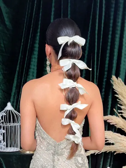 Another angle of the bow-adorned balloon braid, showing its volume and structure.