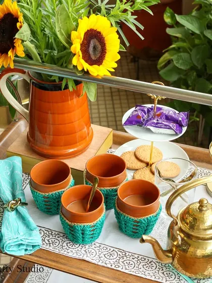 A beautiful tea service set up on a trolley, featuring my handmade crochet cozies for the kulhad clay cups. It’s the little details that make tea time feel special.