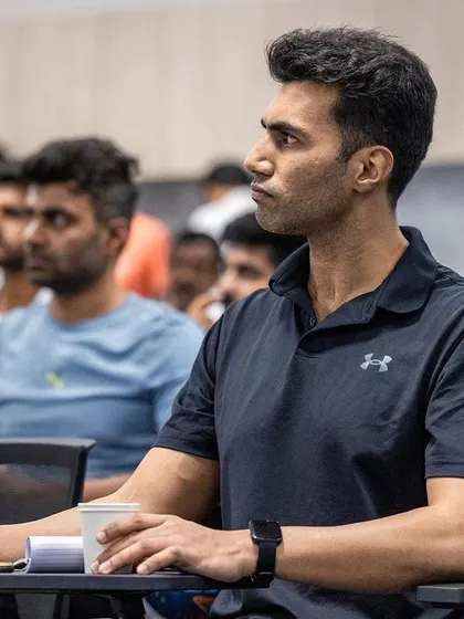 An attendee at the 2024 conference listens carefully, focused on gaining new insights into strength and conditioning.