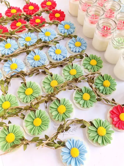 A vibrant collection of daisy soy wax sachets and succulent jar candles made for a 50th birthday celebration, showing how my designs suit any milestone.