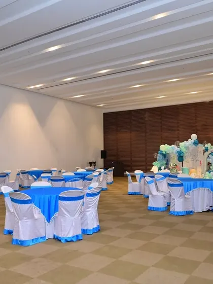 A wide view of the party hall, showing how the 'One-der the Sea' backdrop becomes the focal point of the room. I also coordinate table linens to match the theme.