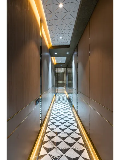 Another view of the hallway, showing the 3D paneled ceiling that adds texture and sophistication. The warm glow from the cove lighting creates an inviting path through the home.