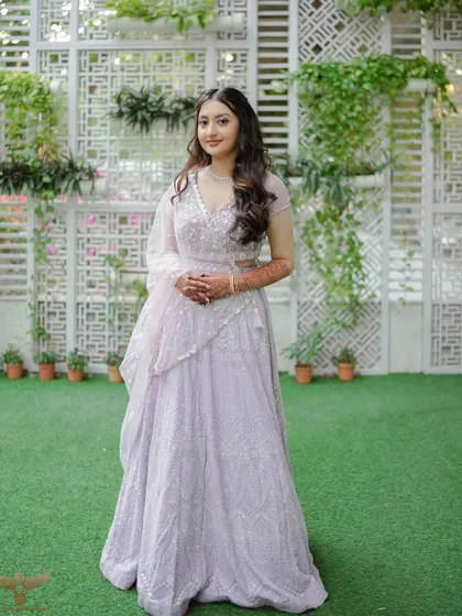 A full-length shot of this bride's Sangeet look. The pastel lehenga is paired with a fun, fresh makeup look, including a pop of color on the eyes.
