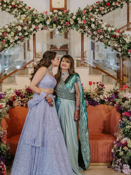 A tender moment between the bride and her mother. The bride's hair looks glamorous and elegant.