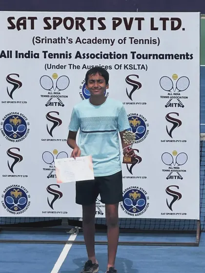 A solo shot of Abheer with his first AITA singles trophy. We celebrate every milestone with our players.
