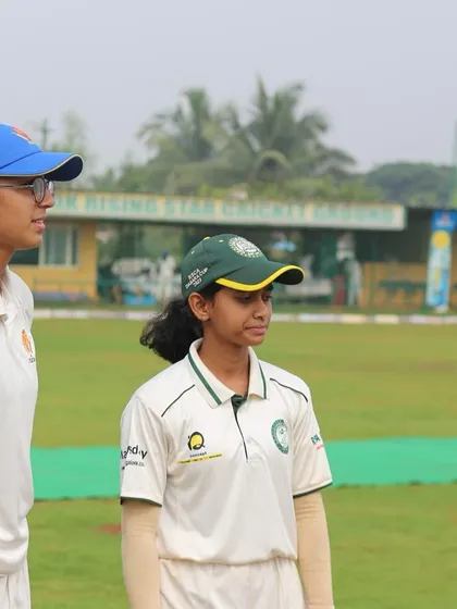 The captains and officials meet at the pitch for the toss before a women's match.