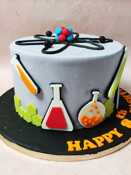 We make learning delicious with this creative science-themed cake. Featuring an atomic structure on top and beakers, flasks, and molecules around the side, this cake is the perfect formula for a budding scientist's birthday.