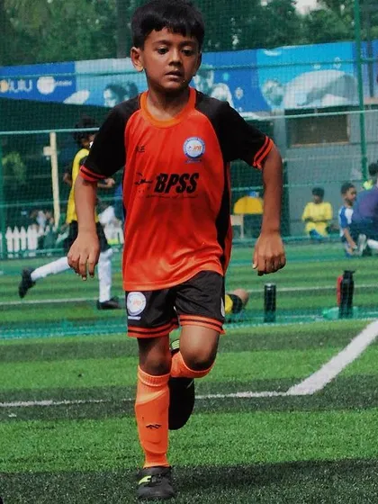 A young player from our U-9 team dribbling down the field during a match. My training focuses on building speed and confidence with the ball.