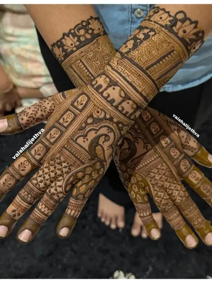 An elegant back-hand design featuring a peacock and elephant. The mix of bold figures and delicate patterns creates a balanced and beautiful composition.