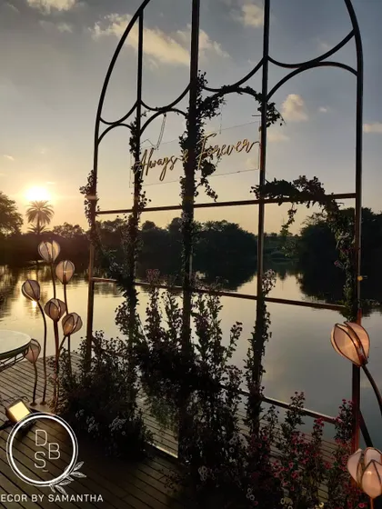 The reception backdrop set against the still waters of a natural lake at sunset. The changing colors of the sky created the most beautiful, evolving canvas for the "Always & Forever" sign.