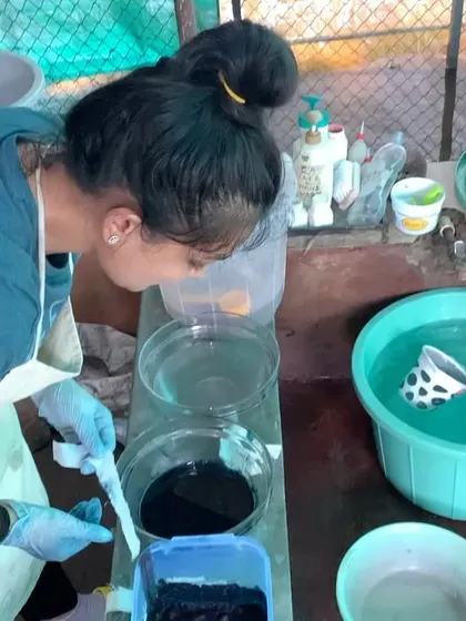 Here I am carefully tending to my indigo vat. Maintaining the health of the vat is a crucial and scientific part of the process, ensuring consistent and vibrant blue colors in every batch.