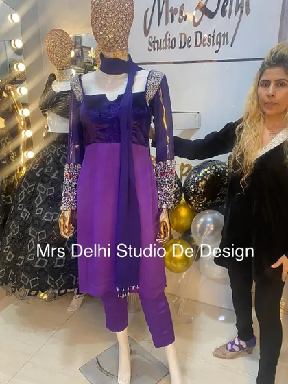 Me with one of my creations. This royal purple suit is a perfect example of the unique, hand-worked traditional wear we are known for.