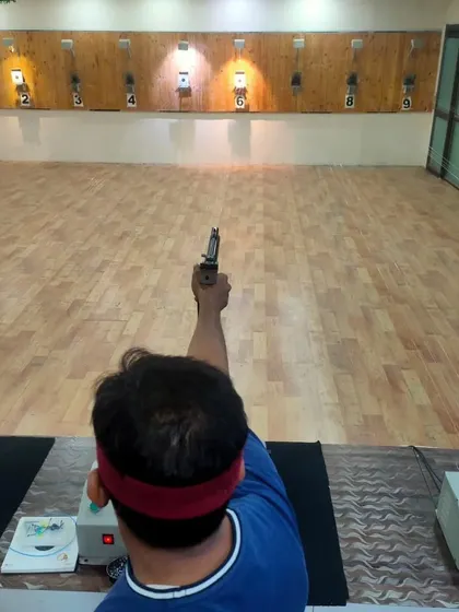 A shooter's perspective, aiming down the lane with an air pistol. This is where you learn to control your breathing and steady your hand.