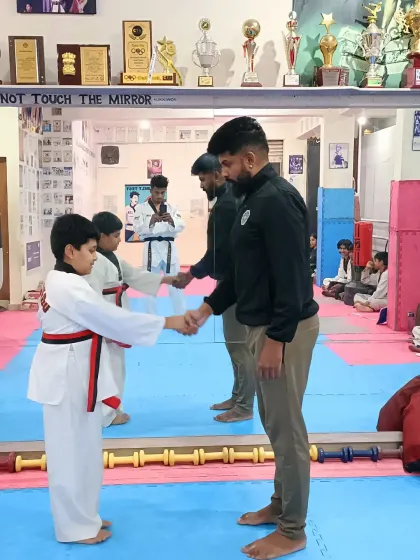 Awarding a red belt to a deserving student.
