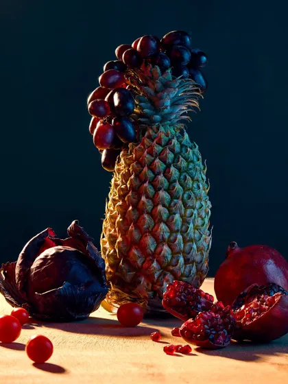 Part of my "Fru-Veg" series, this image features a pineapple crowned with grapes, surrounded by other fruits and vegetables. The lighting is inspired by classical paintings, creating a dramatic, moody still life.